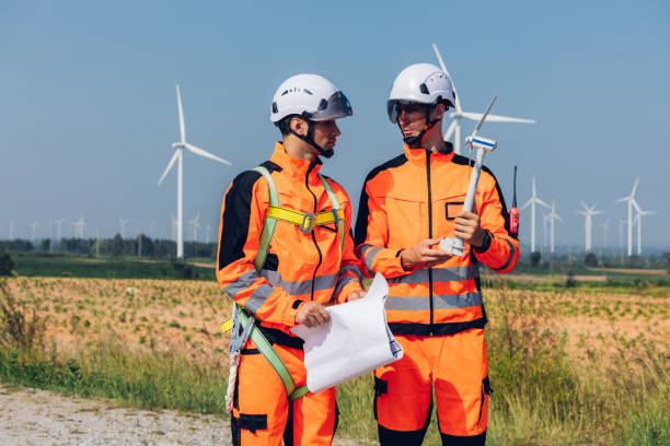 Survey Team Alternative energy for future. Engineers survey and checking wind turbines in sunset. Wind Turbine Renewable energy technology and sustainability.